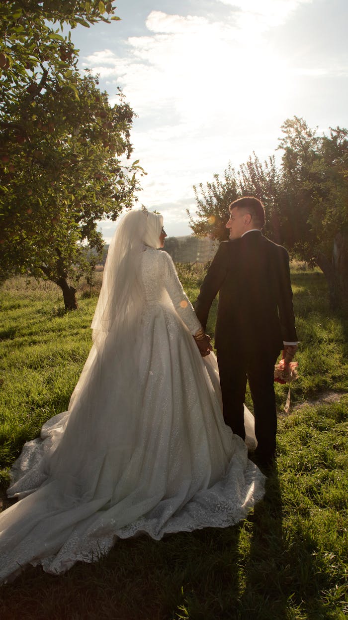 Bride and groom holding hands in a picturesque outdoor setting, beautifully captured in natural light.